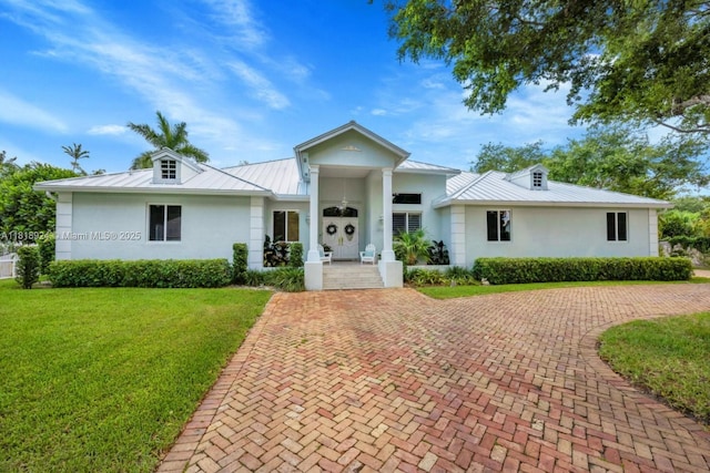 6129 SW 74th Ct, Miami, FL 33143 - view of front of house with a standing seam roof, stucco siding, a metal roof, a front yard, and covered porch