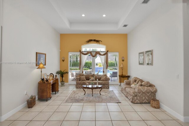 6129 SW 74th Ct, Miami, FL 33143 - living area with arched walkways, light tile patterned flooring, a raised ceiling, and recessed lighting