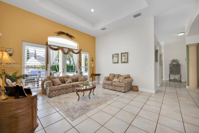 6129 SW 74th Ct, Miami, FL 33143 - living room with light tile patterned floors, a towering ceiling, a tray ceiling, and recessed lighting