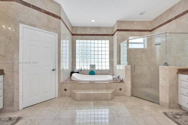 6129 SW 74th Ct, Miami, FL 33143 - full bathroom with a garden tub, a stall shower, tile walls, and vanity