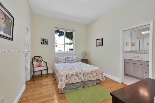 6129 SW 74th Ct, Miami, FL 33143 - bedroom with light wood-style floors and connected bathroom