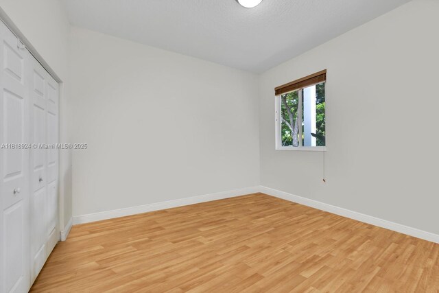 6129 SW 74th Ct, Miami, FL 33143 - unfurnished bedroom with light wood-type flooring and a closet