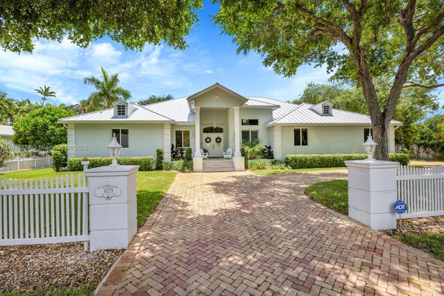6129 SW 74th Ct, Miami, FL 33143 - ranch-style house with a standing seam roof, a metal roof, stucco siding, and a fenced front yard