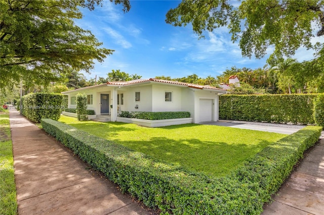 840 Algeria Ave, Coral Gables, FL 33134 - mediterranean / spanish house with a tiled roof, an attached garage, stucco siding, a front lawn, and driveway