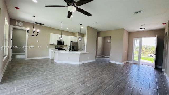 1115 Leader St, La Belle, FL 33935 - unfurnished living room featuring baseboards, a chandelier, a sink, and ceiling fan