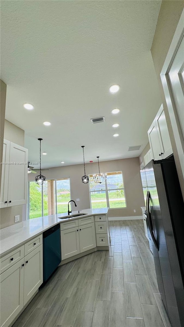 1115 Leader St, La Belle, FL 33935 - kitchen with dishwasher, a sink, stainless steel fridge with ice dispenser, light wood-style flooring, and white cabinets