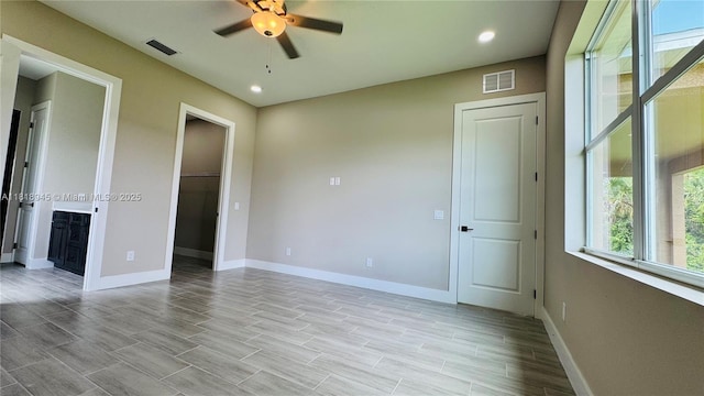 1115 Leader St, La Belle, FL 33935 - unfurnished bedroom featuring a spacious closet, baseboards, recessed lighting, connected bathroom, and light wood finished floors