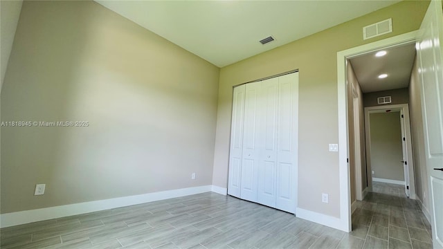 1115 Leader St, La Belle, FL 33935 - unfurnished bedroom featuring baseboards, a closet, light wood-type flooring, and recessed lighting