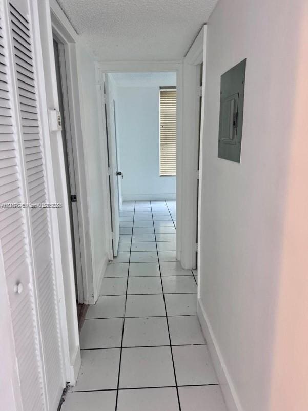 9678 Fontainebleau Blvd Unit 111, Miami, FL 33172 - hall featuring electric panel, light tile patterned flooring, and a textured ceiling