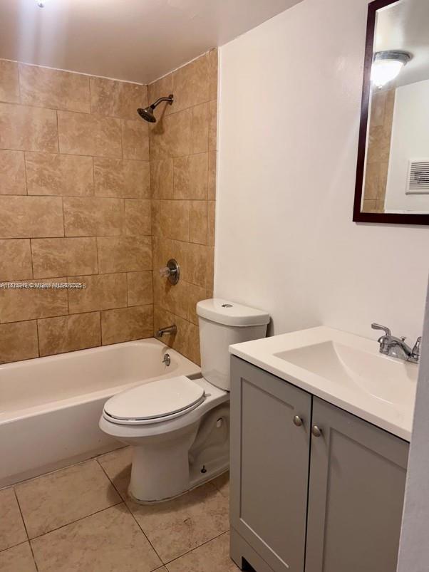 9678 Fontainebleau Blvd Unit 111, Miami, FL 33172 - bathroom featuring vanity, tile patterned flooring, and bathing tub / shower combination