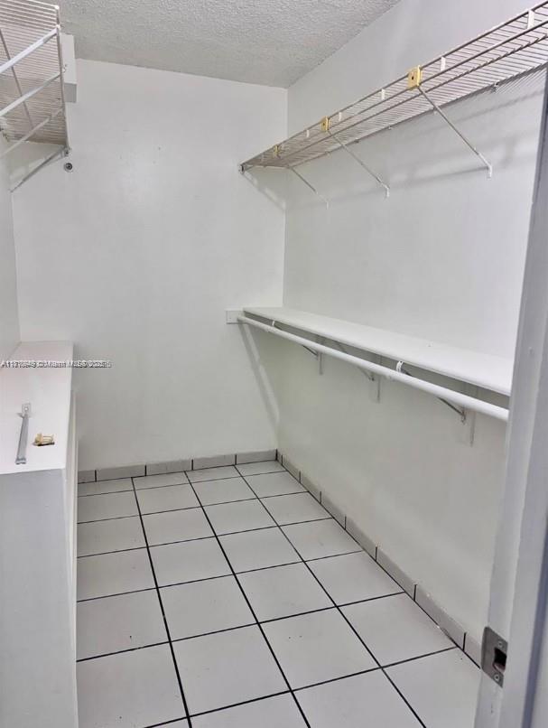 9678 Fontainebleau Blvd Unit 111, Miami, FL 33172 - walk in closet with light tile patterned floors
