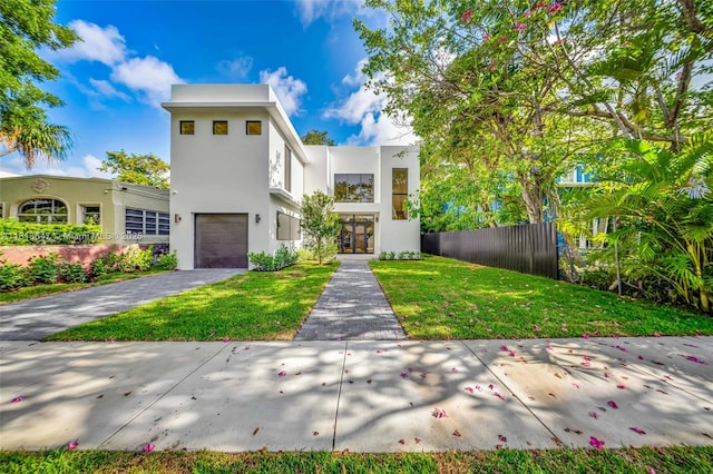 1513 SW 11th Ter, Miami, FL 33135 - contemporary house with an attached garage, stucco siding, driveway, and french doors