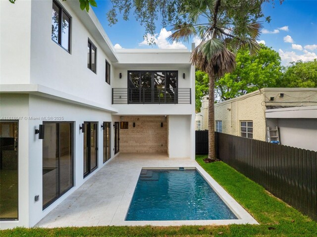 1513 SW 11th Ter, Miami, FL 33135 - back of house featuring a balcony, stucco siding, and a patio