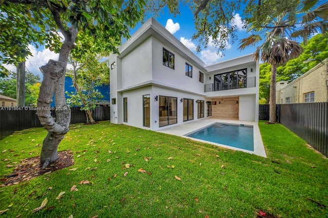 1513 SW 11th Ter, Miami, FL 33135 - back of property featuring a balcony, stucco siding, and a patio area