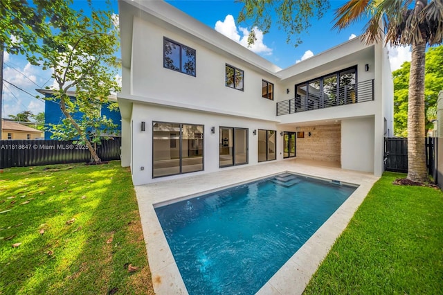 1513 SW 11th Ter, Miami, FL 33135 - rear view of property with a balcony, stucco siding, and a patio area