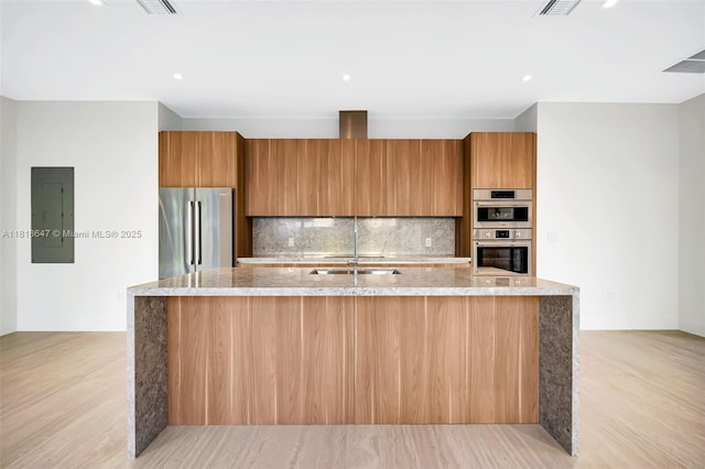 1513 SW 11th Ter, Miami, FL 33135 - kitchen with appliances with stainless steel finishes, electric panel, brown cabinets, light stone countertops, and recessed lighting
