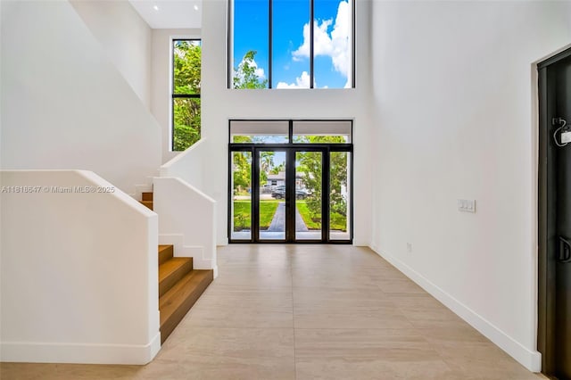1513 SW 11th Ter, Miami, FL 33135 - foyer with a high ceiling, stairs, and baseboards