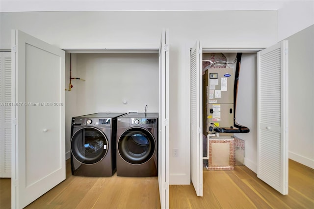 1513 SW 11th Ter, Miami, FL 33135 - washroom with light wood-style floors, independent washer and dryer, and baseboards