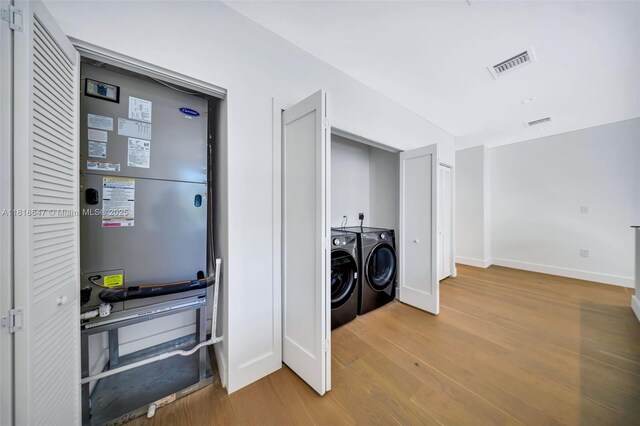 1513 SW 11th Ter, Miami, FL 33135 - laundry area with wood finished floors, washer and dryer, and baseboards