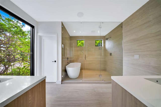 1513 SW 11th Ter, Miami, FL 33135 - full bathroom featuring tile walls, vanity, healthy amount of natural light, a shower stall, and a freestanding bath
