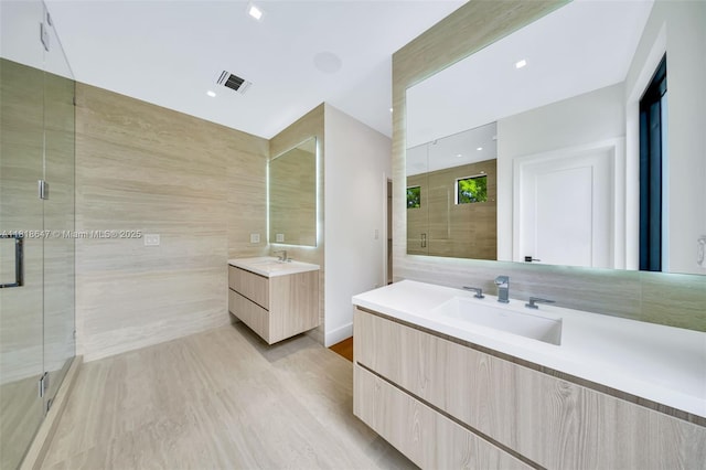 1513 SW 11th Ter, Miami, FL 33135 - bathroom with a shower stall, two vanities, and wood finished floors