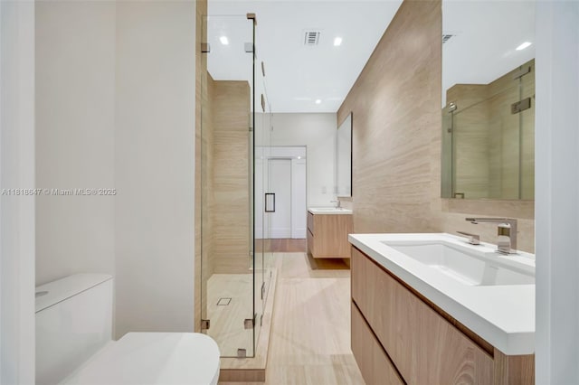 1513 SW 11th Ter, Miami, FL 33135 - bathroom featuring a shower stall, two vanities, tile walls, and toilet
