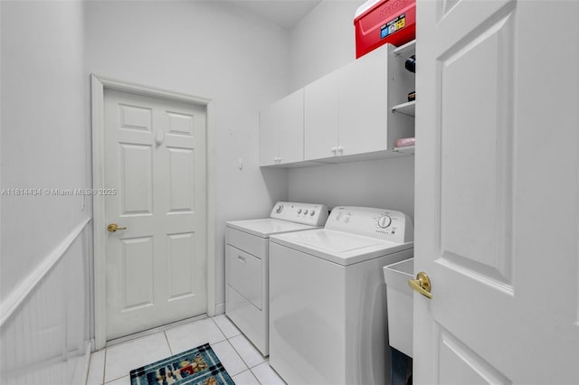 769 SW Munjack Cir, Port St Lucie, FL 34986 - laundry room with separate washer and dryer, cabinet space, and light tile patterned floors