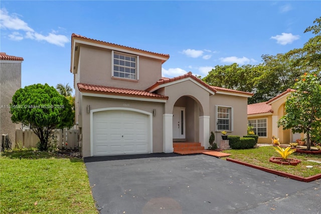 12633 NW 12th Ct, Sunrise, FL 33323 - mediterranean / spanish house featuring stucco siding, a front yard, asphalt driveway, and an attached garage