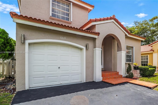 12633 NW 12th Ct, Sunrise, FL 33323 - mediterranean / spanish-style house with stucco siding, a garage, a tiled roof, and driveway