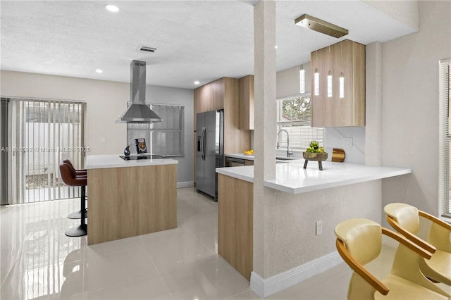12633 NW 12th Ct, Sunrise, FL 33323 - kitchen with stainless steel fridge with ice dispenser, island exhaust hood, modern cabinets, a breakfast bar area, and light countertops