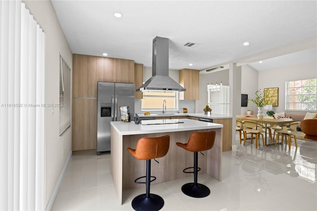 12633 NW 12th Ct, Sunrise, FL 33323 - kitchen with stainless steel refrigerator with ice dispenser, island exhaust hood, modern cabinets, light countertops, and a center island