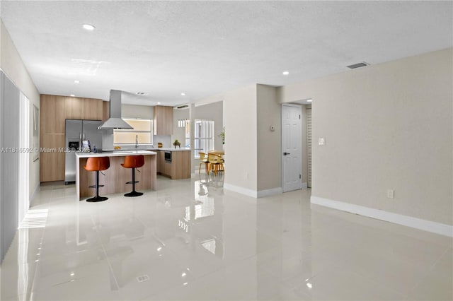 12633 NW 12th Ct, Sunrise, FL 33323 - kitchen with modern cabinets, ventilation hood, a kitchen island, a kitchen bar, and light countertops
