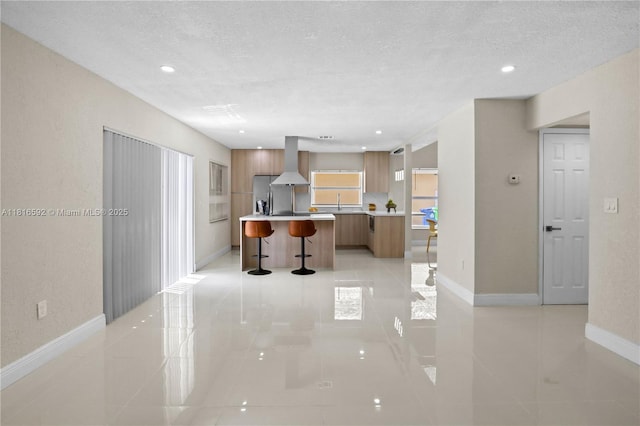 12633 NW 12th Ct, Sunrise, FL 33323 - kitchen featuring modern cabinets, a breakfast bar area, island range hood, a center island, and light countertops