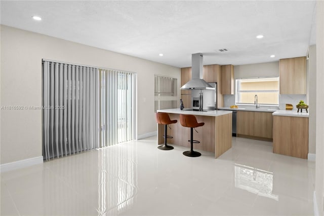 12633 NW 12th Ct, Sunrise, FL 33323 - kitchen with island range hood, modern cabinets, a breakfast bar area, light countertops, and a center island