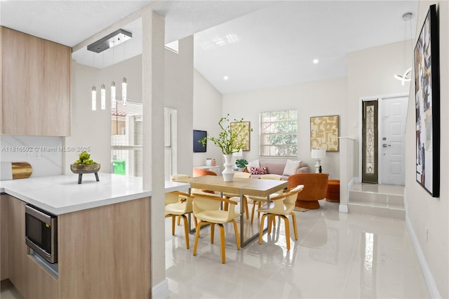 12633 NW 12th Ct, Sunrise, FL 33323 - dining space with baseboards, light tile patterned flooring, and high vaulted ceiling