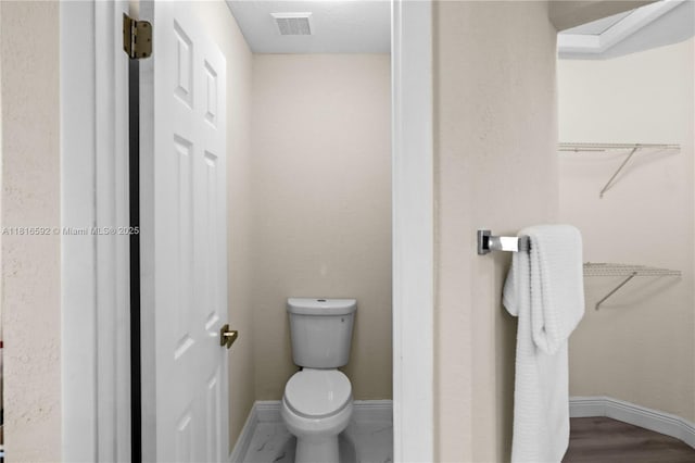 12633 NW 12th Ct, Sunrise, FL 33323 - bathroom with toilet, baseboards, and a walk in closet