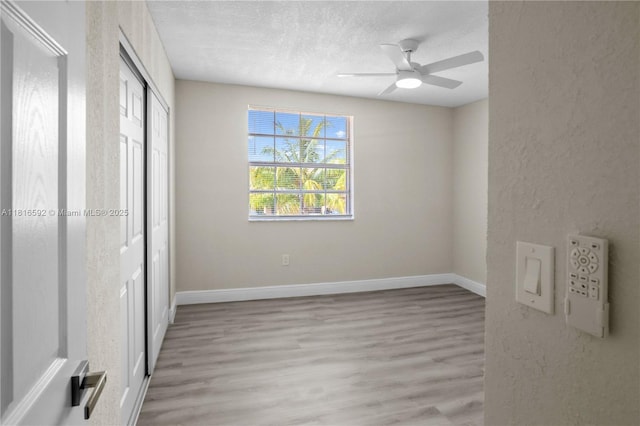 12633 NW 12th Ct, Sunrise, FL 33323 - unfurnished bedroom featuring light wood-type flooring, a textured ceiling, baseboards, a closet, and ceiling fan