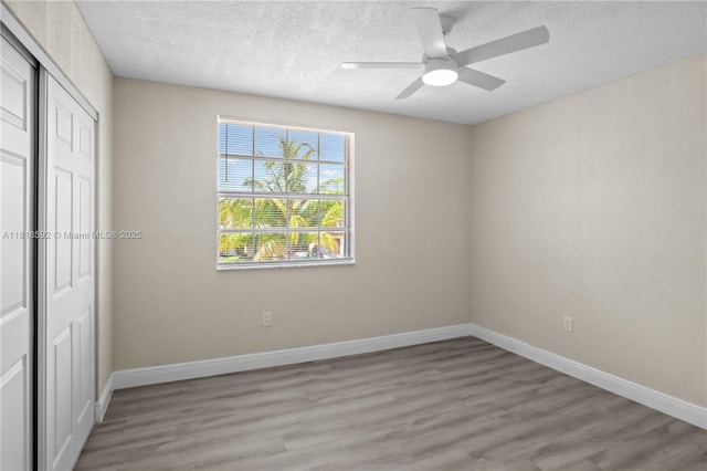 12633 NW 12th Ct, Sunrise, FL 33323 - unfurnished bedroom with light wood-style flooring, a closet, a textured ceiling, baseboards, and a ceiling fan