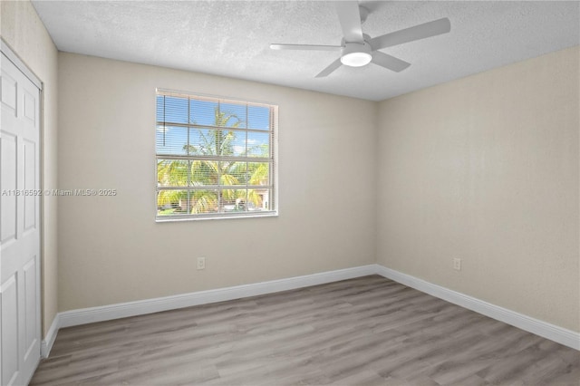 12633 NW 12th Ct, Sunrise, FL 33323 - unfurnished bedroom with light wood-style flooring, a textured ceiling, baseboards, a closet, and a ceiling fan