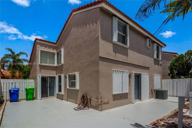 12633 NW 12th Ct, Sunrise, FL 33323 - back of property with stucco siding, a patio area, central air condition unit, and a tiled roof