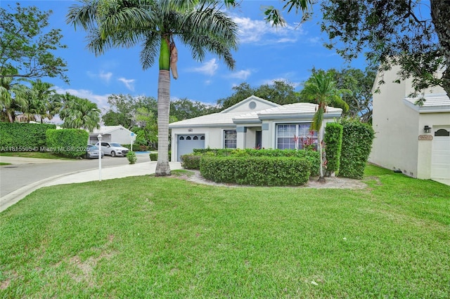 9601 NW 8th Cir, Plantation, FL 33324 - single story home with concrete driveway, an attached garage, a front yard, and stucco siding