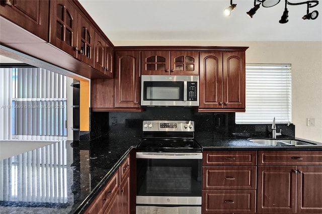 9601 NW 8th Cir, Plantation, FL 33324 - kitchen featuring appliances with stainless steel finishes, a sink, backsplash, and dark stone counters