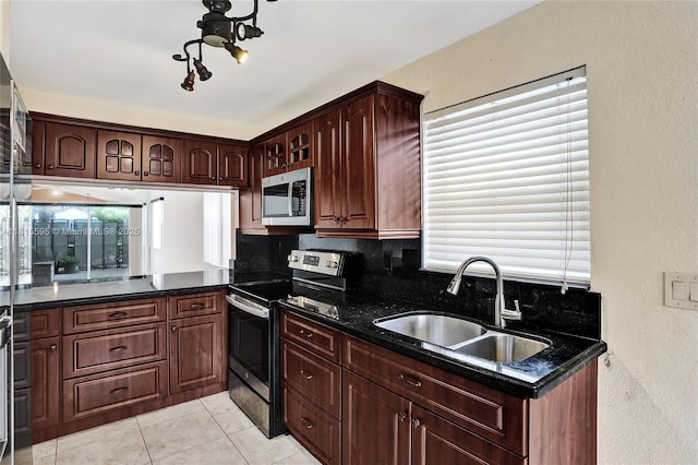 9601 NW 8th Cir, Plantation, FL 33324 - kitchen featuring stainless steel appliances, a sink, tasteful backsplash, light tile patterned flooring, and a textured wall