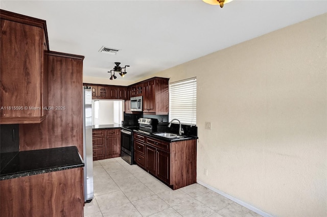 9601 NW 8th Cir, Plantation, FL 33324 - kitchen featuring stainless steel appliances, a sink, light tile patterned floors, baseboards, and dark stone counters
