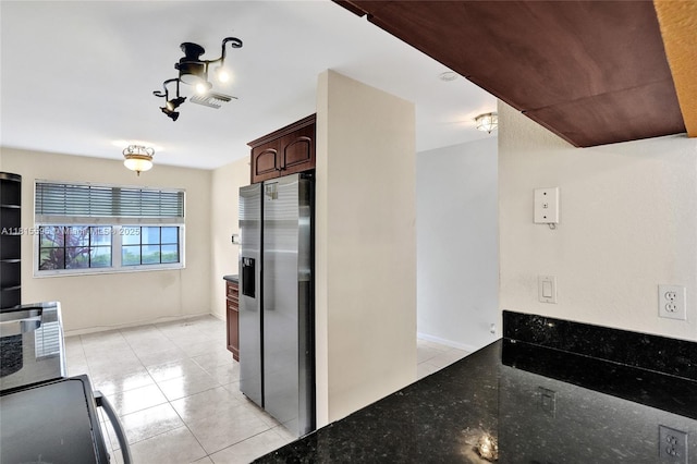 9601 NW 8th Cir, Plantation, FL 33324 - kitchen featuring stainless steel fridge with ice dispenser, light tile patterned floors, dark stone counters, stove, and dark brown cabinets