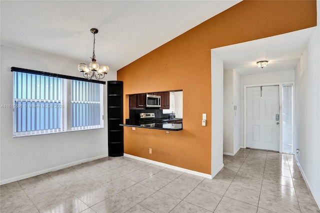 9601 NW 8th Cir, Plantation, FL 33324 - kitchen with stainless steel appliances, a chandelier, dark countertops, light tile patterned floors, and baseboards