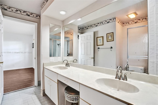 9601 NW 8th Cir, Plantation, FL 33324 - bathroom with tile patterned floors, double vanity, baseboards, and a shower with door