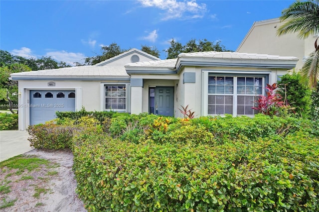 9601 NW 8th Cir, Plantation, FL 33324 - view of front of property featuring a garage, stucco siding, driveway, and a tile roof