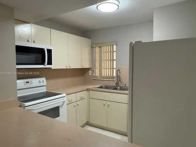 870 NW 87th Ave Unit 310, Miami, FL 33172 - kitchen with white appliances, a sink, light countertops, and white cabinets