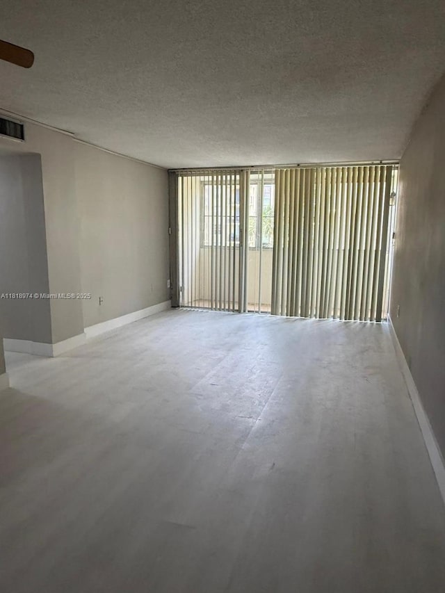 870 NW 87th Ave Unit 310, Miami, FL 33172 - unfurnished room with a textured ceiling and baseboards